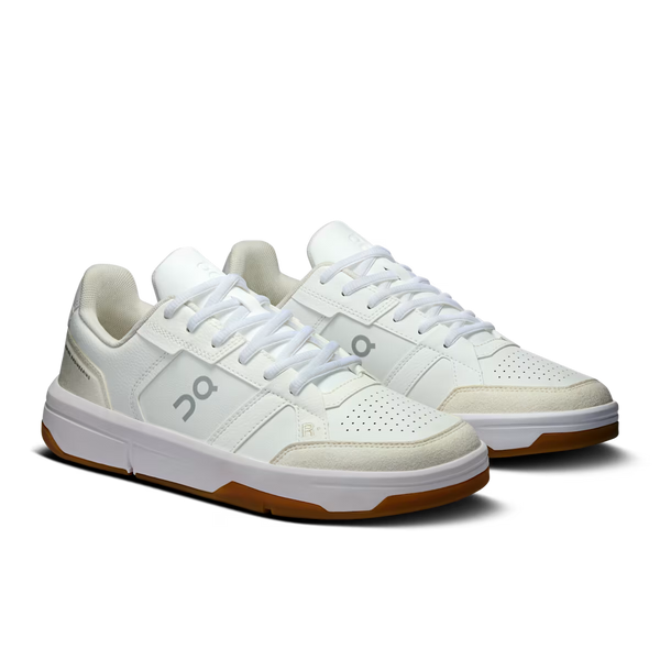 White sneaker with brown sole on a white background