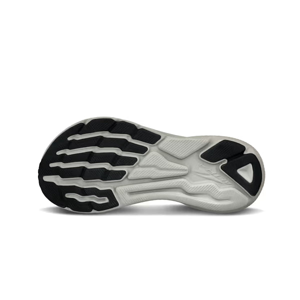 Close-up of a running shoe sole with black and white design on a white background