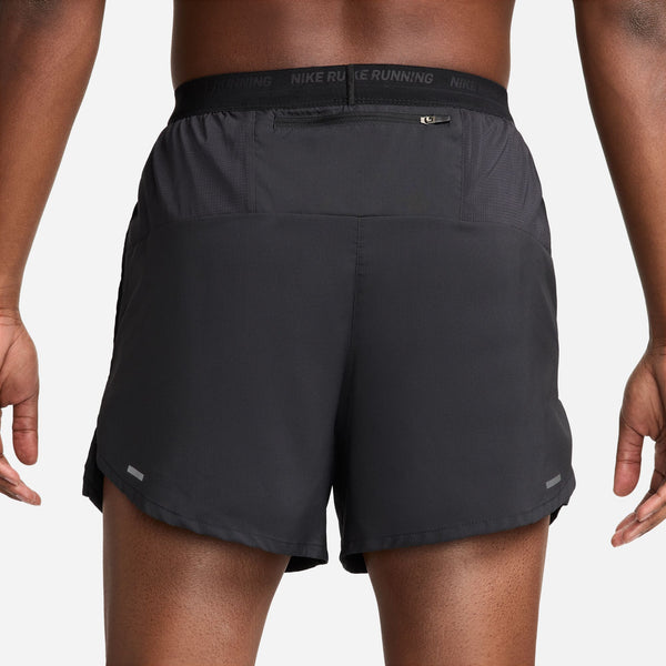 Black running shorts with Nike branding on a white background