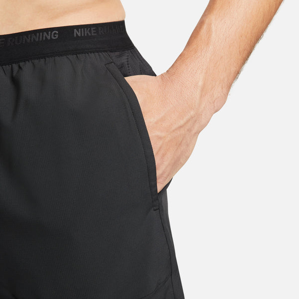 Black Nike running shorts on a white background