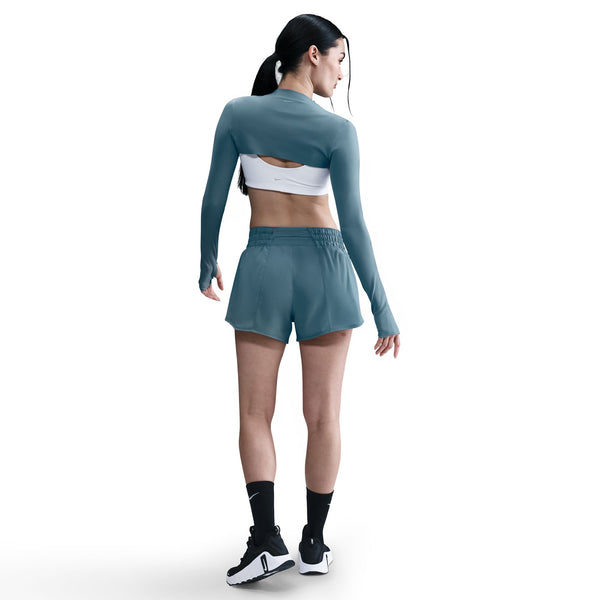 Woman wearing a teal athletic outfit on a white background