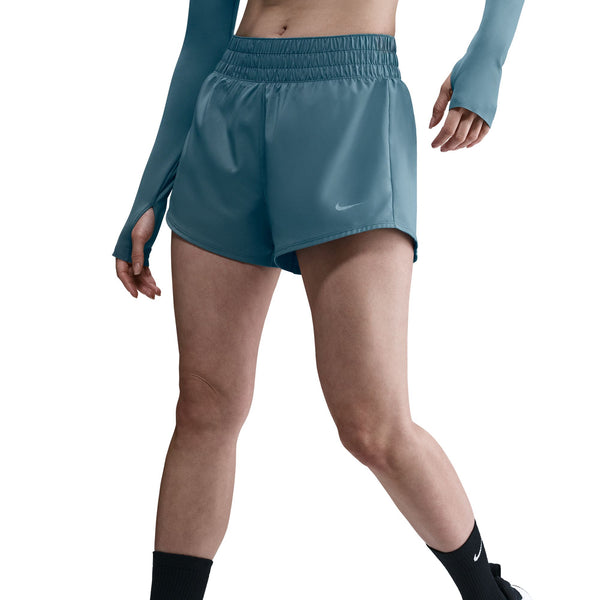 Person wearing teal athletic shorts with a Nike logo on a white background