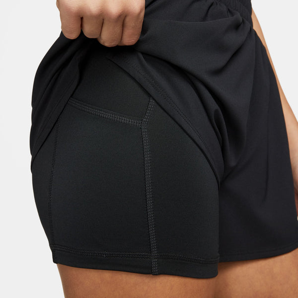 Black athletic shorts being adjusted on a person against a white background