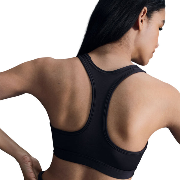 Black sports bra worn by a person on a white background