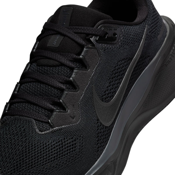 Super Close-up of a black running and athletic shoe with Nike logo on a white background.