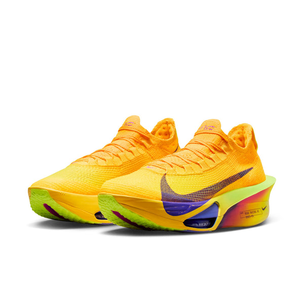 Brightly colored carbon plated running shoes with a Nike logo on a white background.