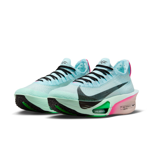 Light blue and black sneakers with green and pink accents on a white background.