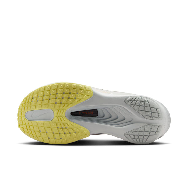 Close-up of a shoe sole with yellow and gray design on a white background