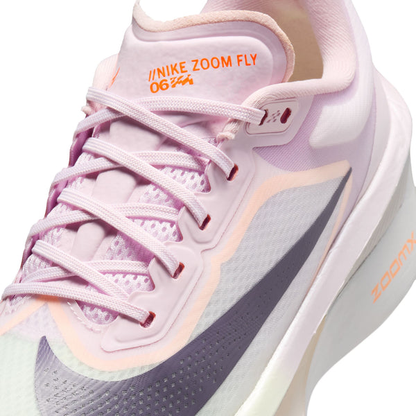 Pink running shoe with white laces and 'Nike Zoom Fly' branding on a white background