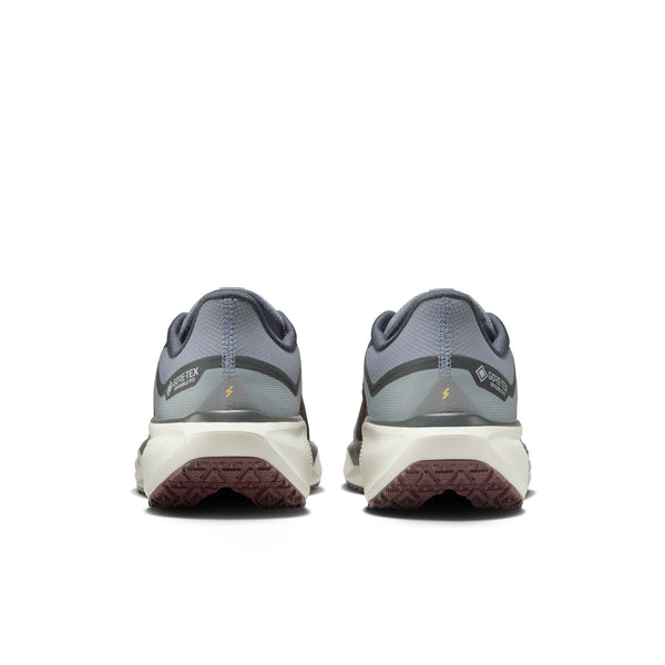 The heel area of these running shoes says Gore-Tex and a lightening bolt to symbolize they are great in tough conditions.
