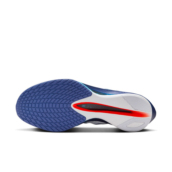 Outsole view of a blue and white athletic shoe with red accents on a white background.