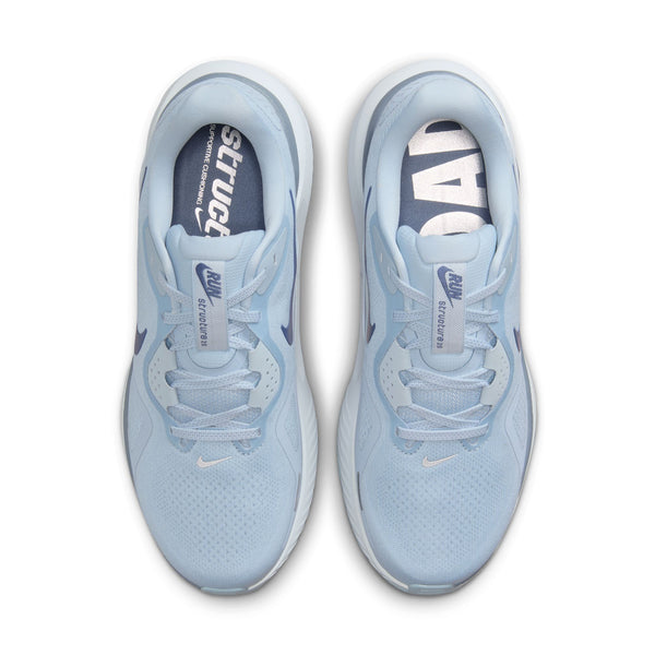 Pair of light blue Nike running shoes on a white background.