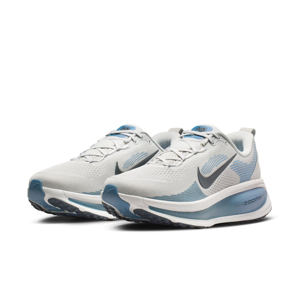 White and blue running shoes with Nike logo on a white background