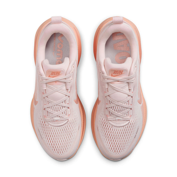 Pair of pink running shoes with 'Nike' branding on a white background.