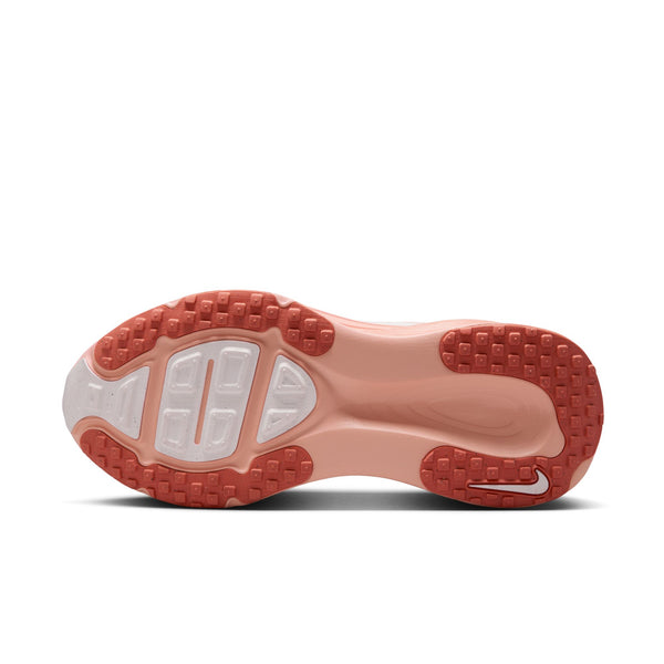 Nike shoe sole with red tread pattern on a white background.