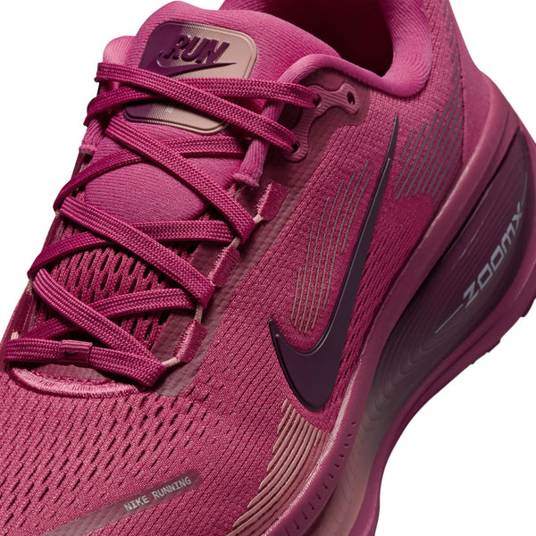 Pink running shoe with Nike logo and 'Zoom' text on a white background.