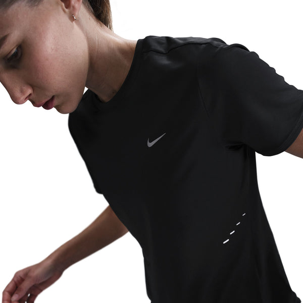 Person wearing a black athletic shirt with a Nike logo on a white background