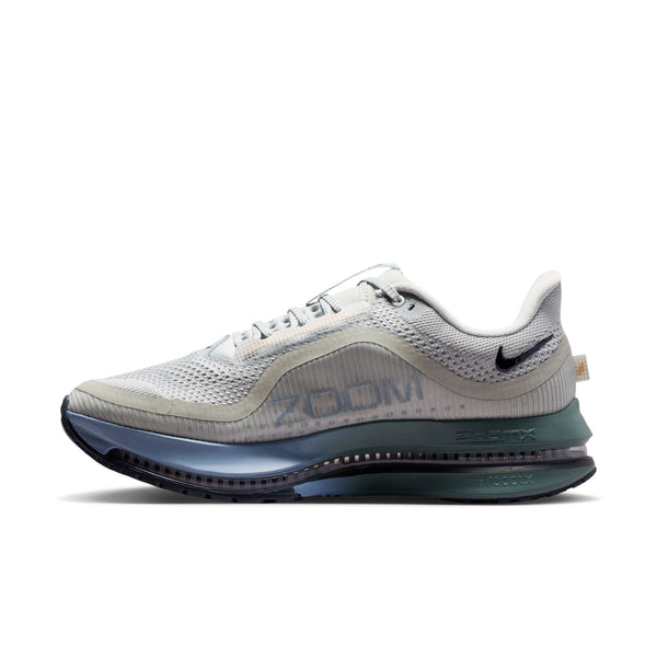 White running shoe with blue sole on a white background
