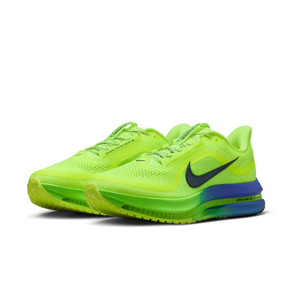 Bright green running shoes with a blue sole on a white background