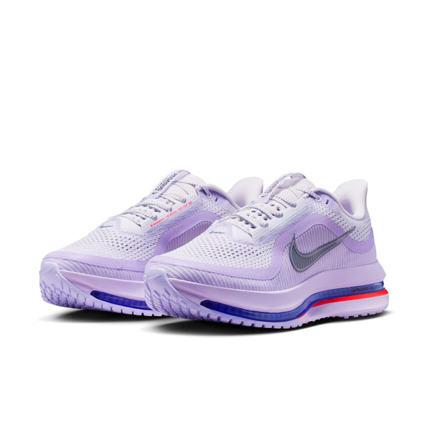 Pair of purple running shoes with a visible Nike logo on a white background