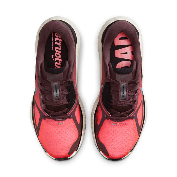 Red and black athletic shoes with visible brand logo on a white background.