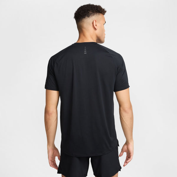 Man wearing a black athletic outfit on a white background