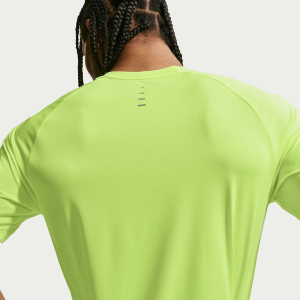 Person wearing a bright green t-shirt on a light gray background
