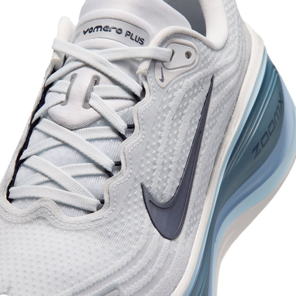 Gray athletic shoe with Nike logo and 'Zoom' text on a white background