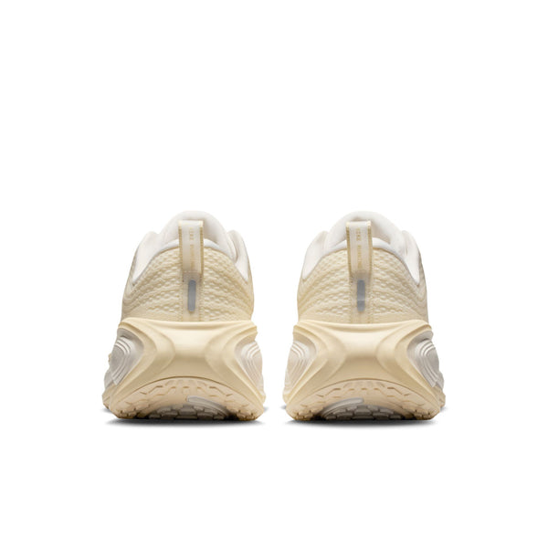 Pair of beige running shoes on a white background