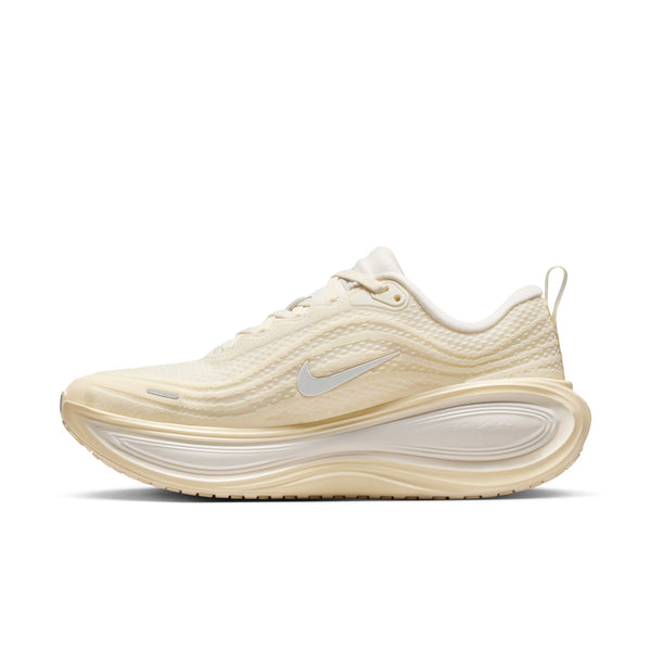 Beige running shoe with a white sole on a white background