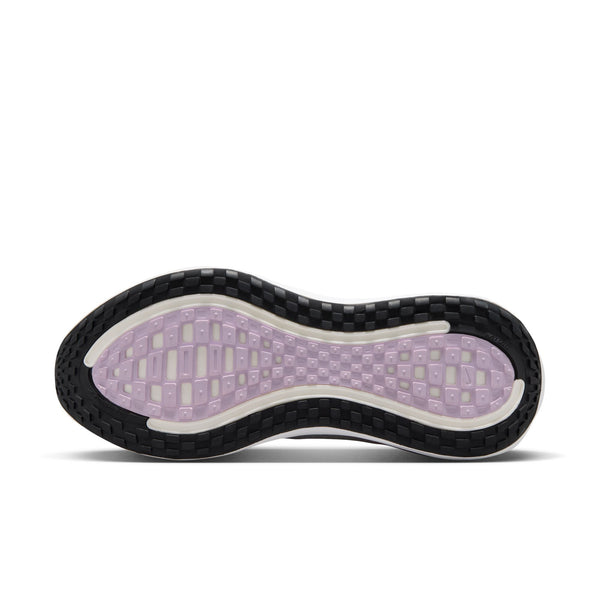 A Nike running shoe in white with a metallic silver Swoosh and a pink ZoomX midsole accent, shown on a white background.