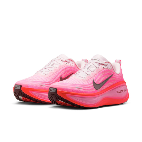 Women's Nike pink running shoes with a black swoosh logo on a white background.