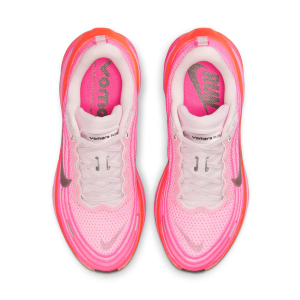 Top down look of a pink and white running shoes with visible brand logo on a white background.