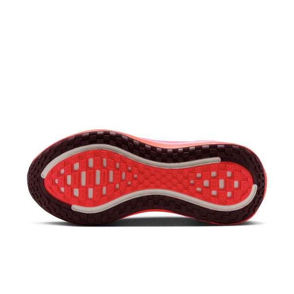 Close-up of a red and black shoe sole on a white background.