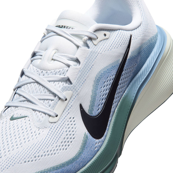 White running shoe with blue accents and black Nike logo on a white background
