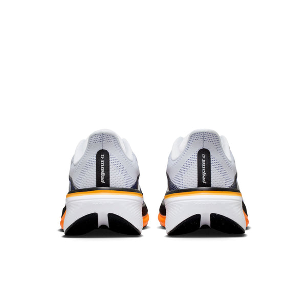 White running shoes with black and orange accents on a white background