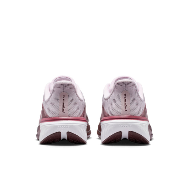 Pair of pink and white running shoes on a white background