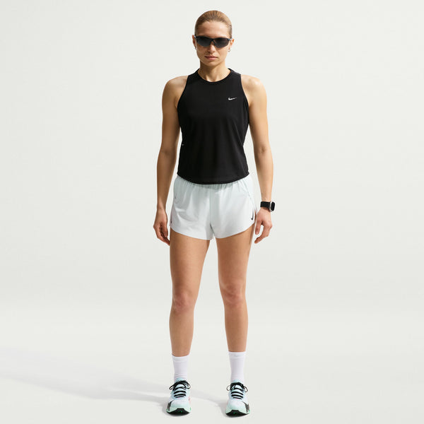 Person wearing a black tank top and white shorts with a Nike logo on a light gray background