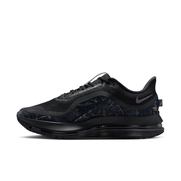 Black athletic shoe with a camouflage pattern on a white background.