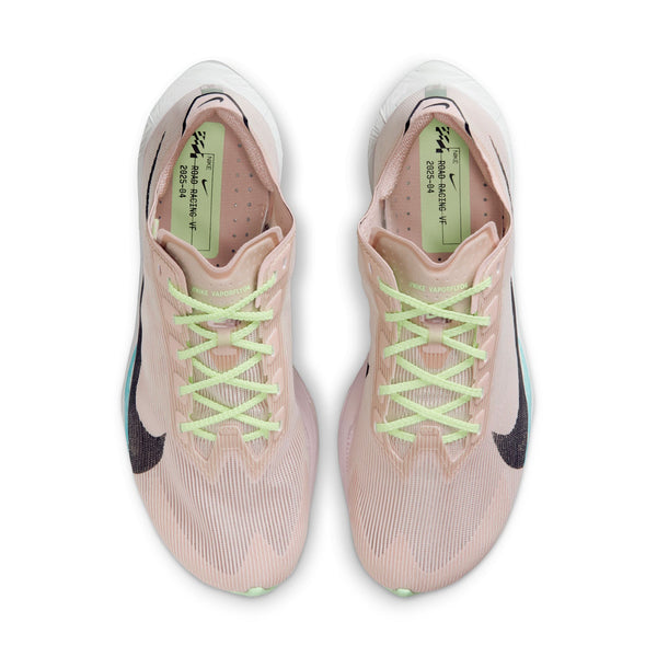 Pair of pink running shoes with green laces on a white background.