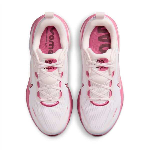 White and pink running shoes with visible branding Nike and Vomero tags on a white background.