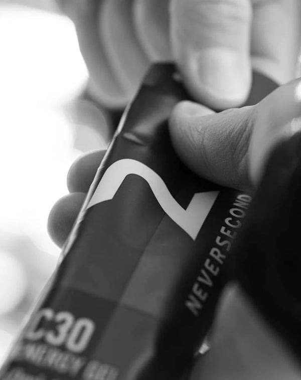 Person holding a 'Never Second' energy drink can
