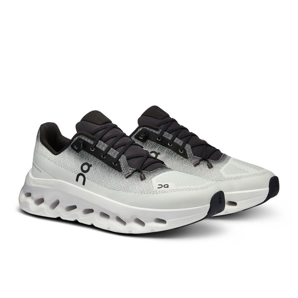 A pair of Men's Cloudtilt with a black tongue adn mostly white upper.