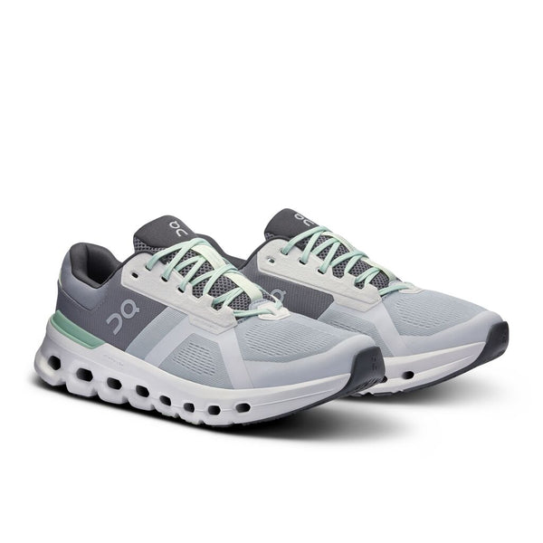 Gray and white running shoes with green accents on a white background.