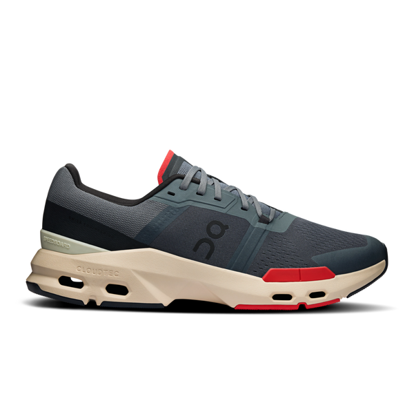 A pair of casual sneakers with a blue upper, beige sole, and red accents.