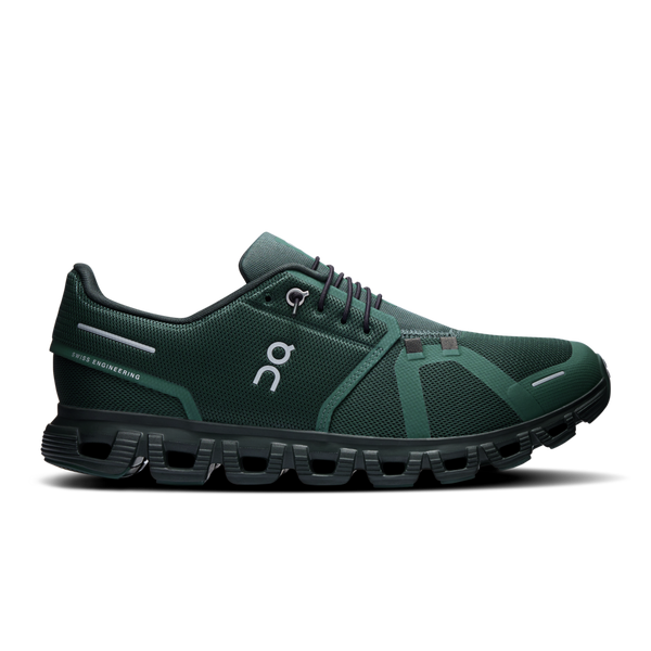 A pair of green On brand athletic shoes with a distinctive logo on the side.