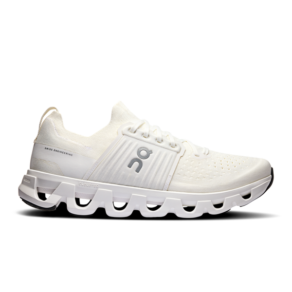 A pair of white athletic shoes with a unique sole design featuring air pockets.