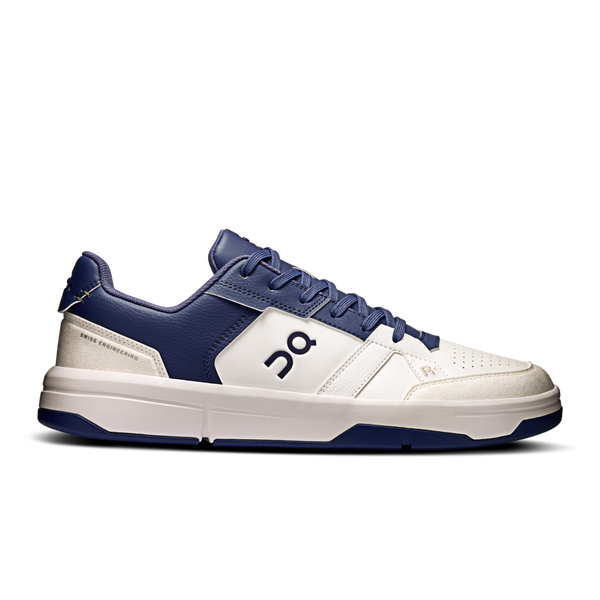 White and blue sneaker with a brand logo on a white background.