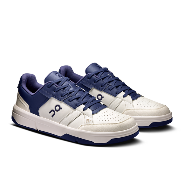 Pair of white and blue sneakers on a white background.