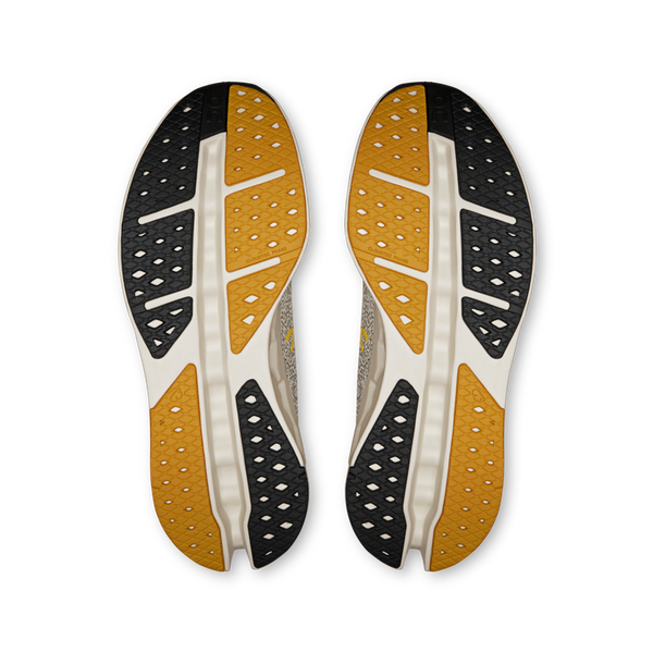 Two shoe insoles with yellow and black sole design on a white background.